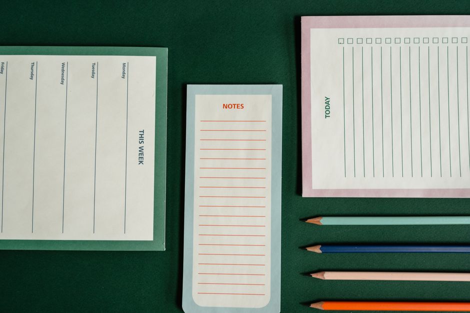 Top view of various notebooks and pencils for effective planning.